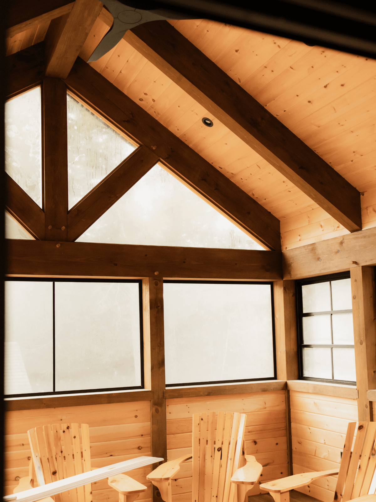 Elegant lakefront timber frame build in Haliburton Highlands with exposed beams and panoramic natural views.