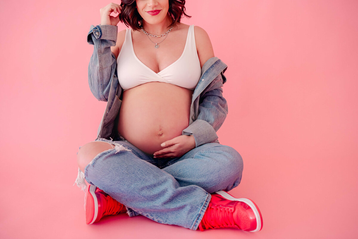 Maternity session in jean jacket and jordans.