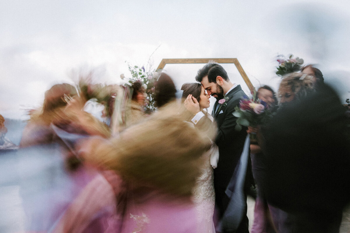 Bride and Groom surrounded by wedding party blur