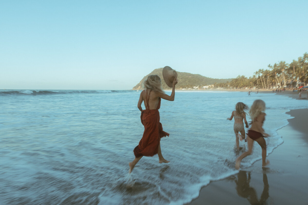 other playing with her children in the water. Fun and playful family photography in Portland and Nashville.