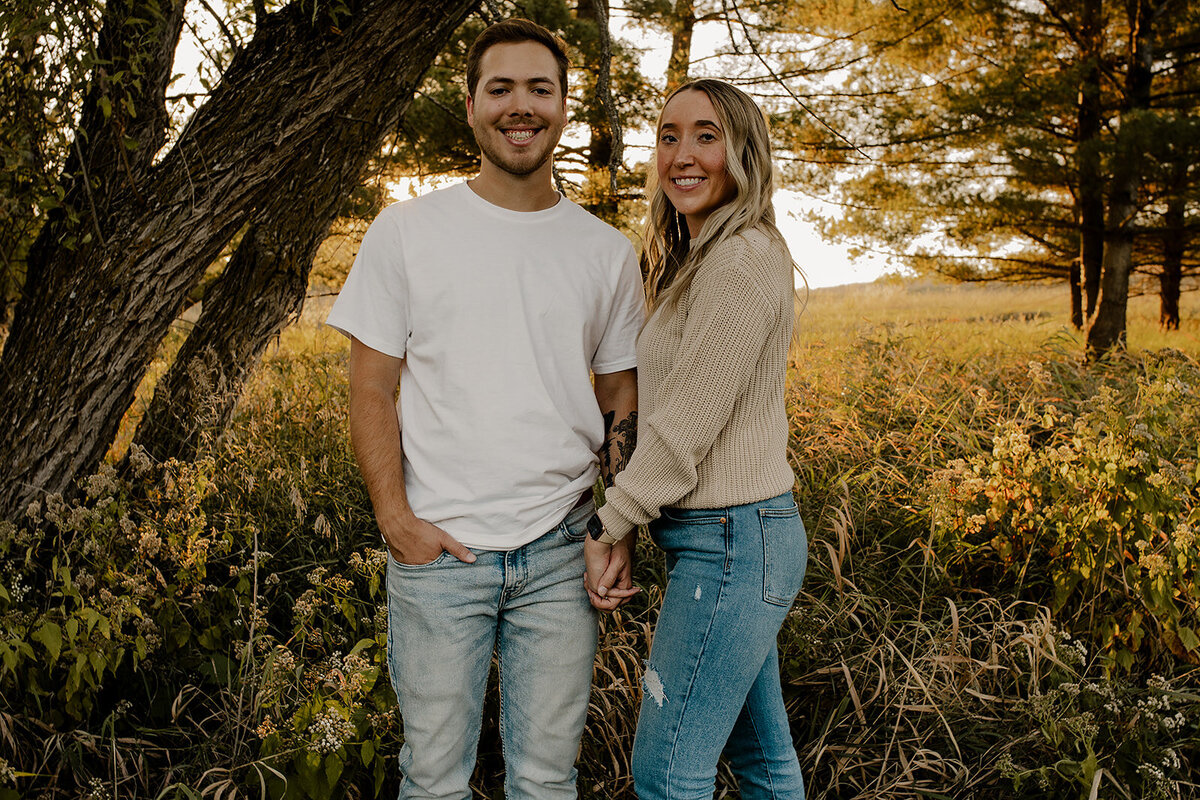 Couple's engagement session in Omaha during golden hour, surrounded by warm fall foliage – captured by Tori Nichole Photography. Authentic, romantic moments in a stunning autumnal setting, reflecting the beauty of the season and their love story.