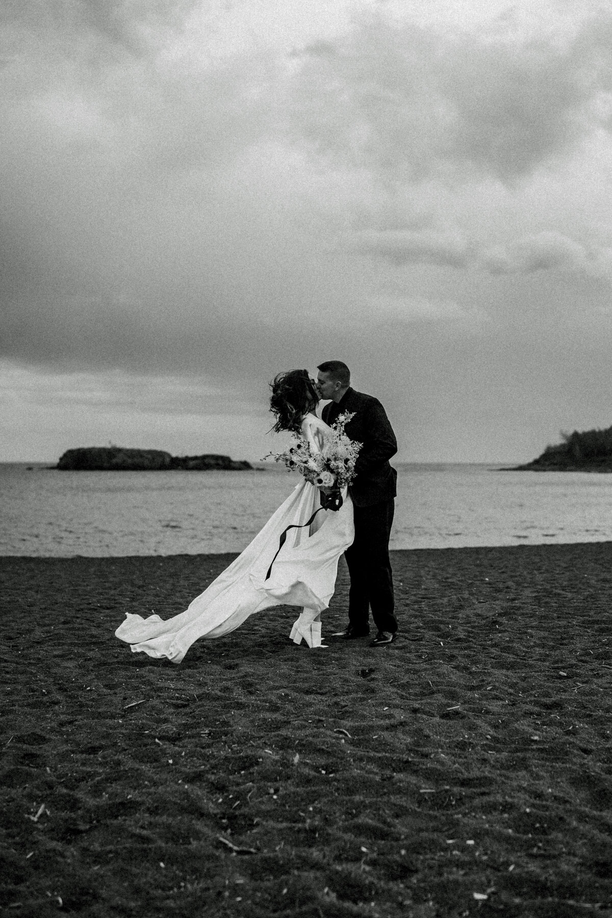 elopement couple in wind by lake