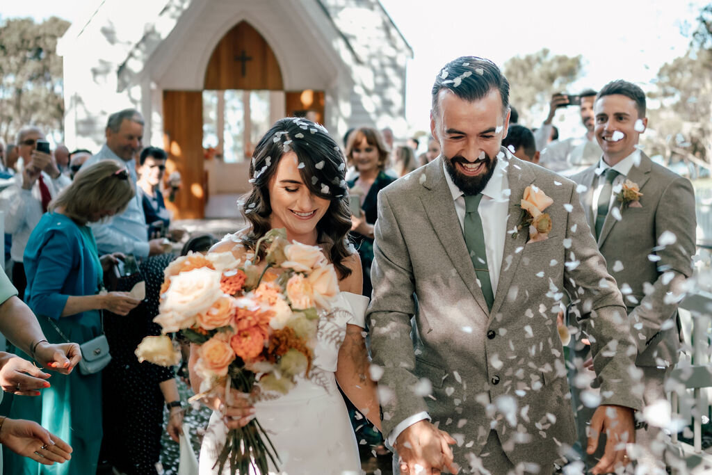 Lorna and Will with their wedding guests during candid outdoor portraits at Waiheke Island, photographed by Zanthe Vorsatz.