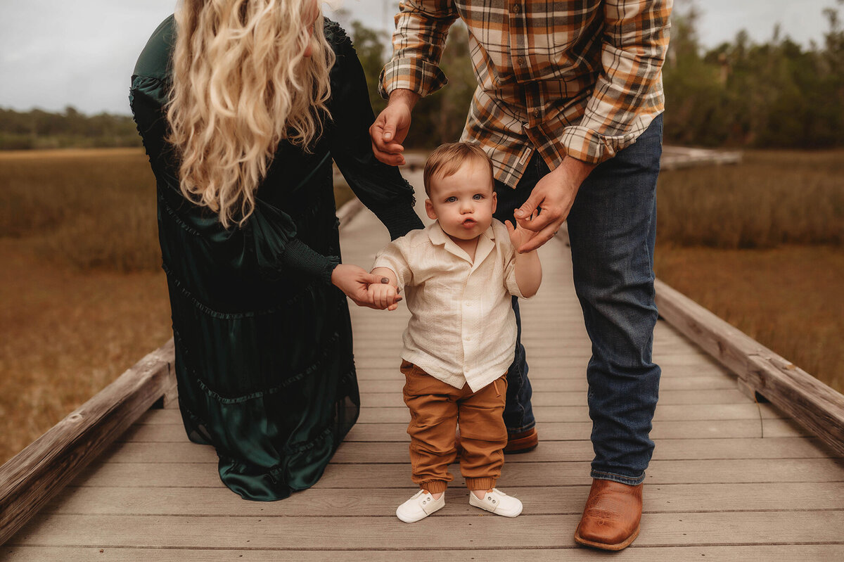 Parents hold their toddlers hands during Family Pictures in Charleston.