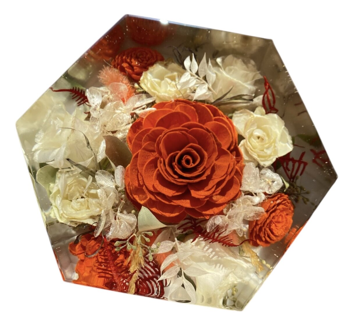 hexagon resin block with bright orange and flowers preserved forever as a family keepsake