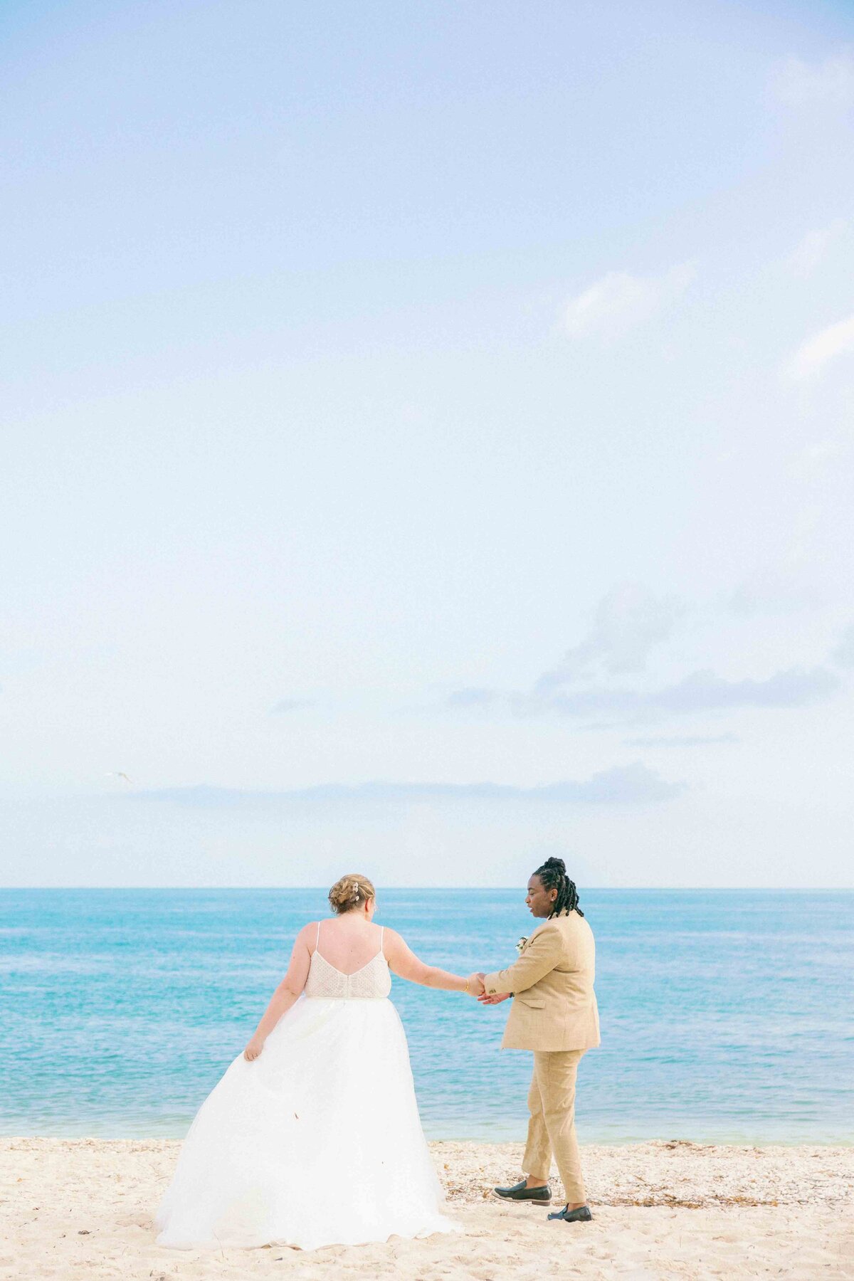 Two brides dance on the beach at Fort Zachary Taylor in Key West