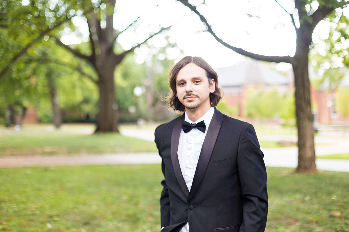 Groom wearing black tuxedo in the grounds of Vanderbilt Alumni Hall, Nashville