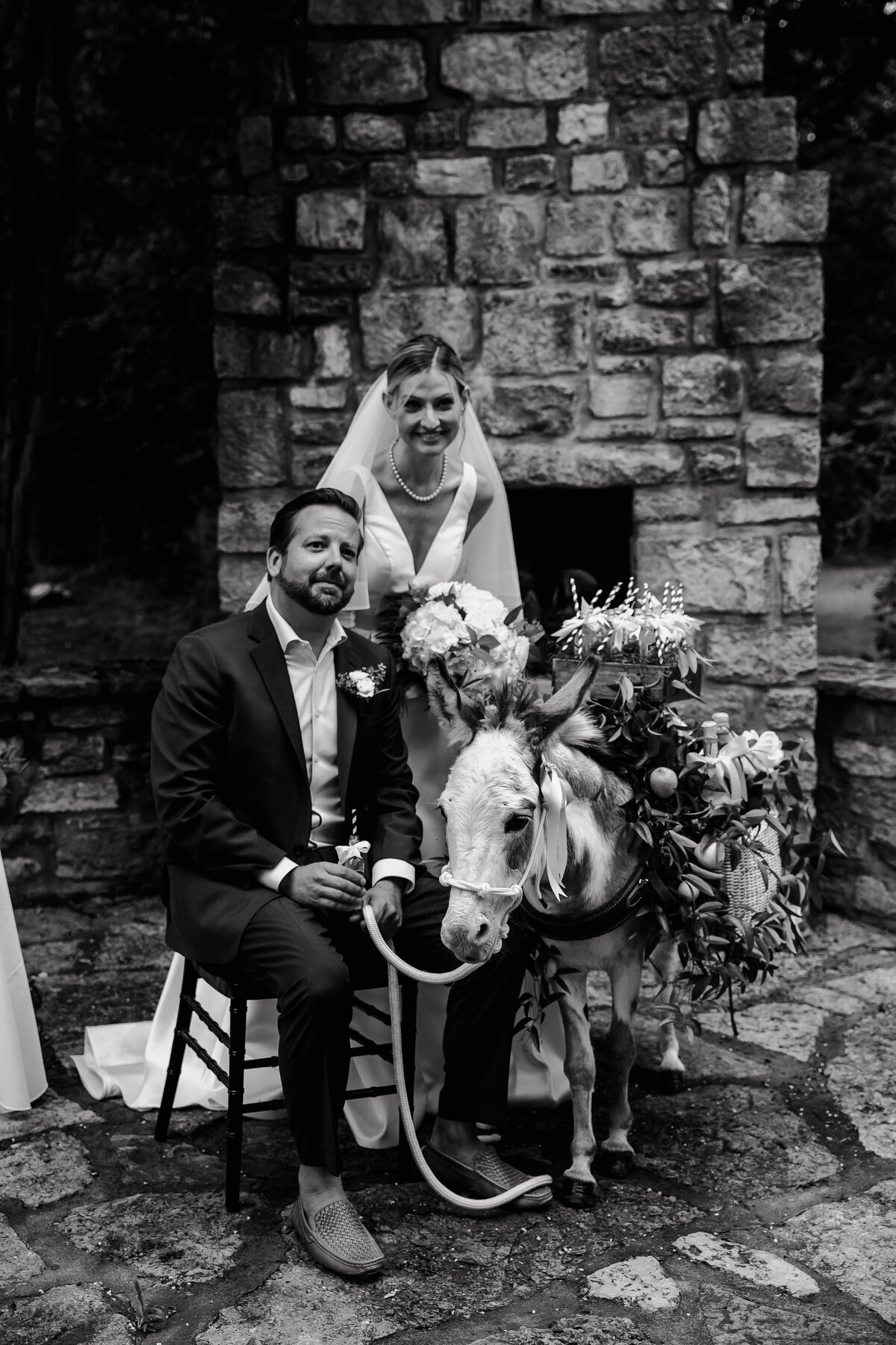 bride and groom with donkey in black and white