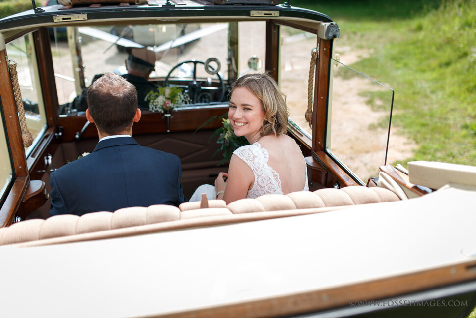 confident smiling bride in vintage car