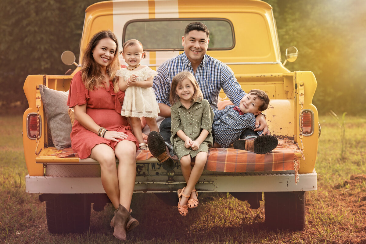 mom dad daughters son vintage truck yellow outdoor park Algiers Point