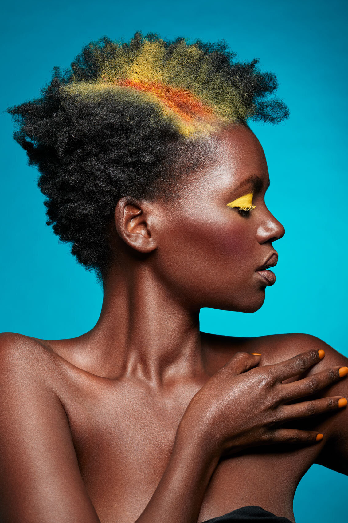 Profile portrait of Lilian with vibrant makeup and striking lighting, captured by Ylva Erevall.