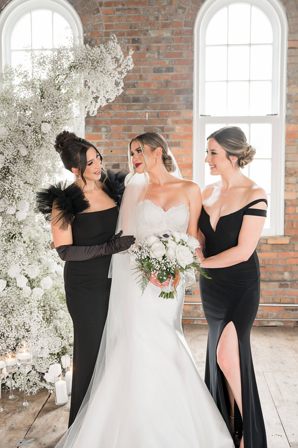 bride and her sisters posing for traditional wedding photo