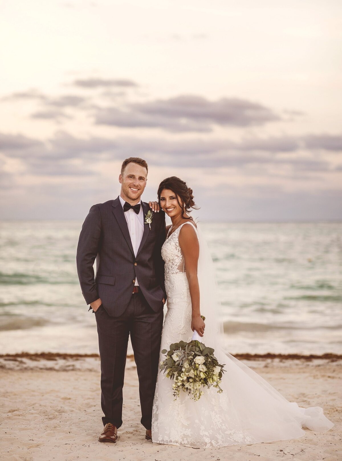Editorial portrait of bride and groom on beach  at Secrets Maroma Riviera Maya