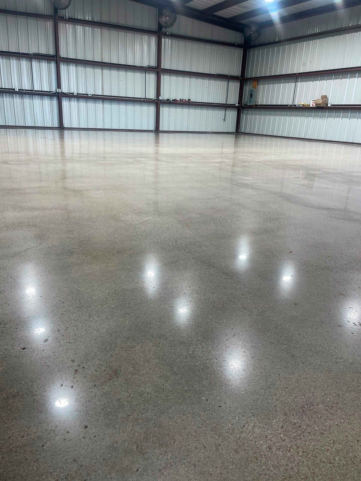 Concrete Polishing for Living Spaces in DFW showcasing a beautifully polished concrete floor in a living room, highlighting the smooth finish and modern aesthetic ideal for residential spaces in the Dallas-Fort Worth area.