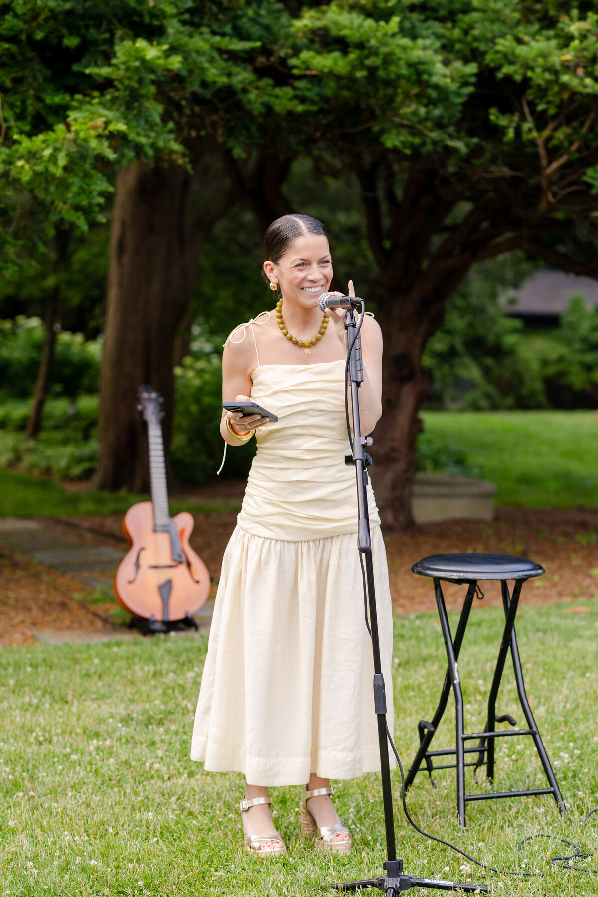 maid of honor giving a speech during the outdoor rehearsal dinner 