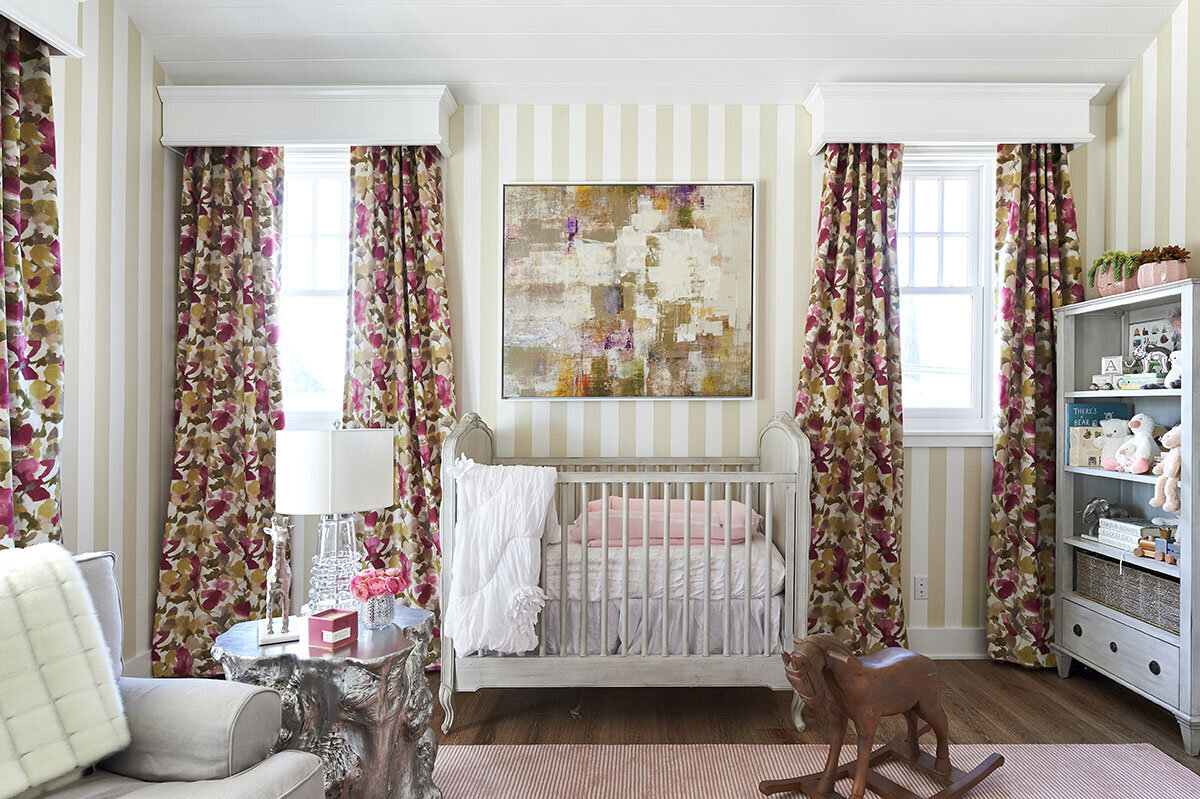 Baby girl nursery with stripe wallpaper
