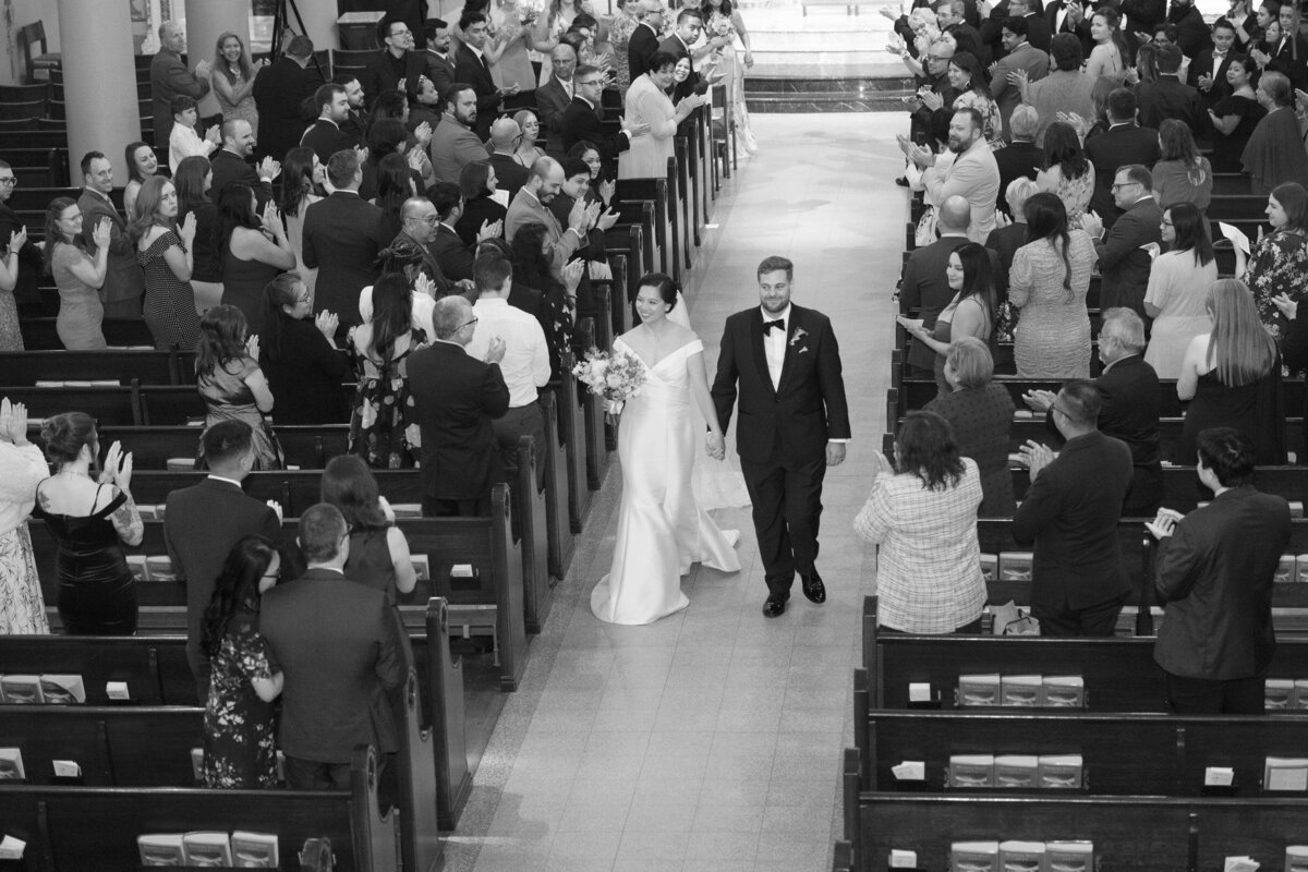 Husband and wife waling down the  Aisle