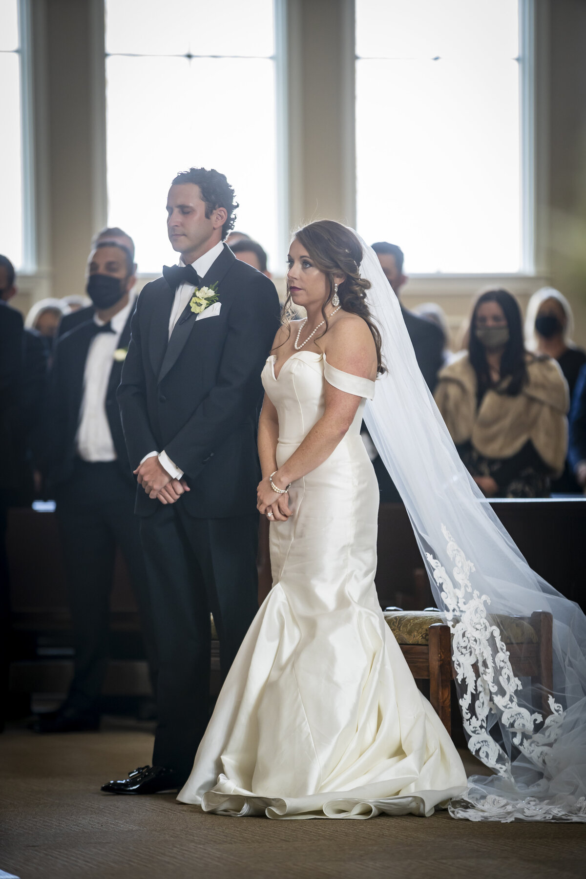 Bride and groom standing in chapel.