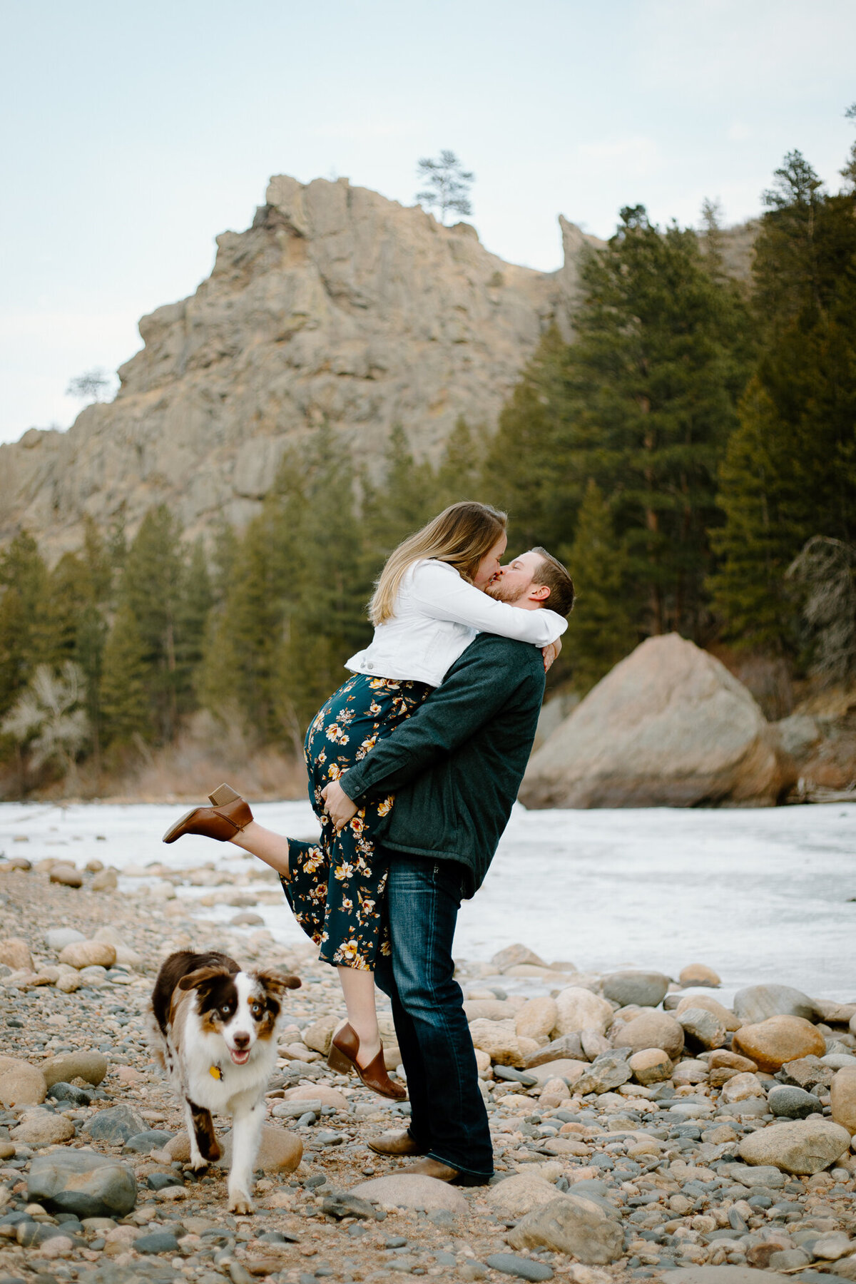 A couple poses for a photo with their dog at Picnic Rock in Fort Collins, Colorado.