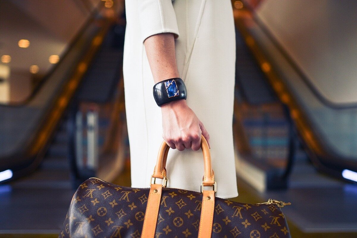 woman traveling with a louis vuitton keepall