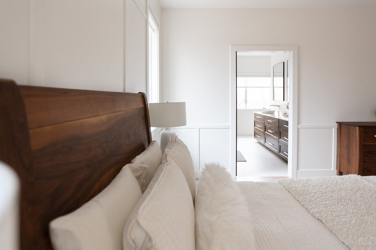 michele rosenboom design clean country renovation bedroom wooden headboard and white bedding