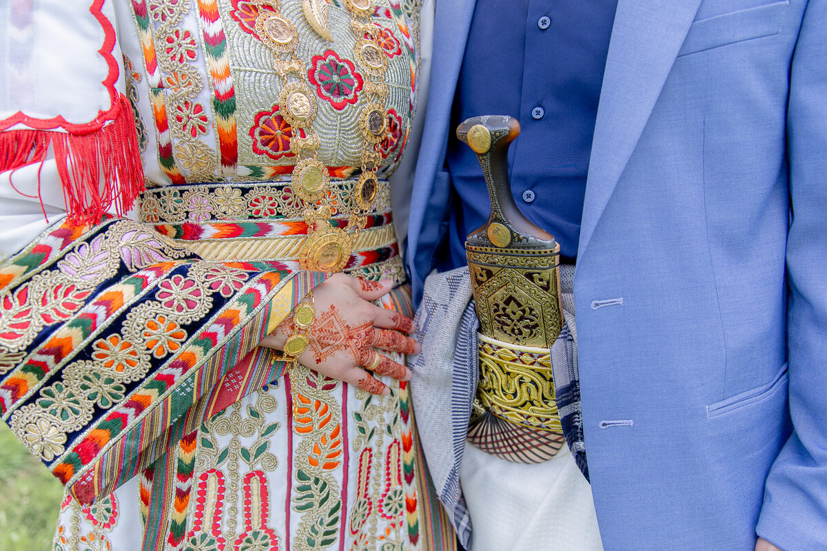 Close up of a couple of their wedding day wearing traditional Palestinian clothing. The photo is cropped so you just see their torsos.