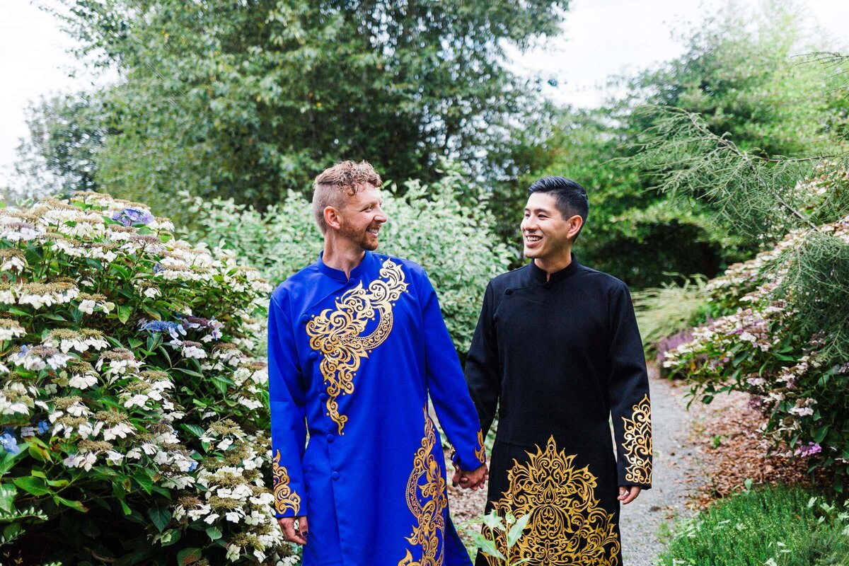 LGBTQ couple holding hands wearing Ao Dais in Olympic National Park