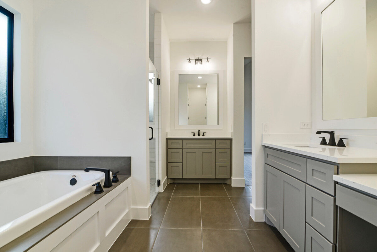 gray shaker style cabinets in bathroom with black faucets