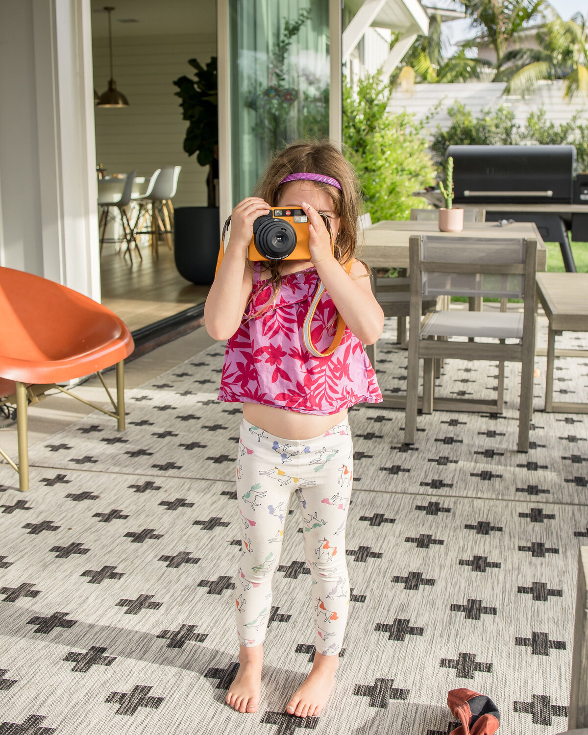 Girl holds polaroid camera