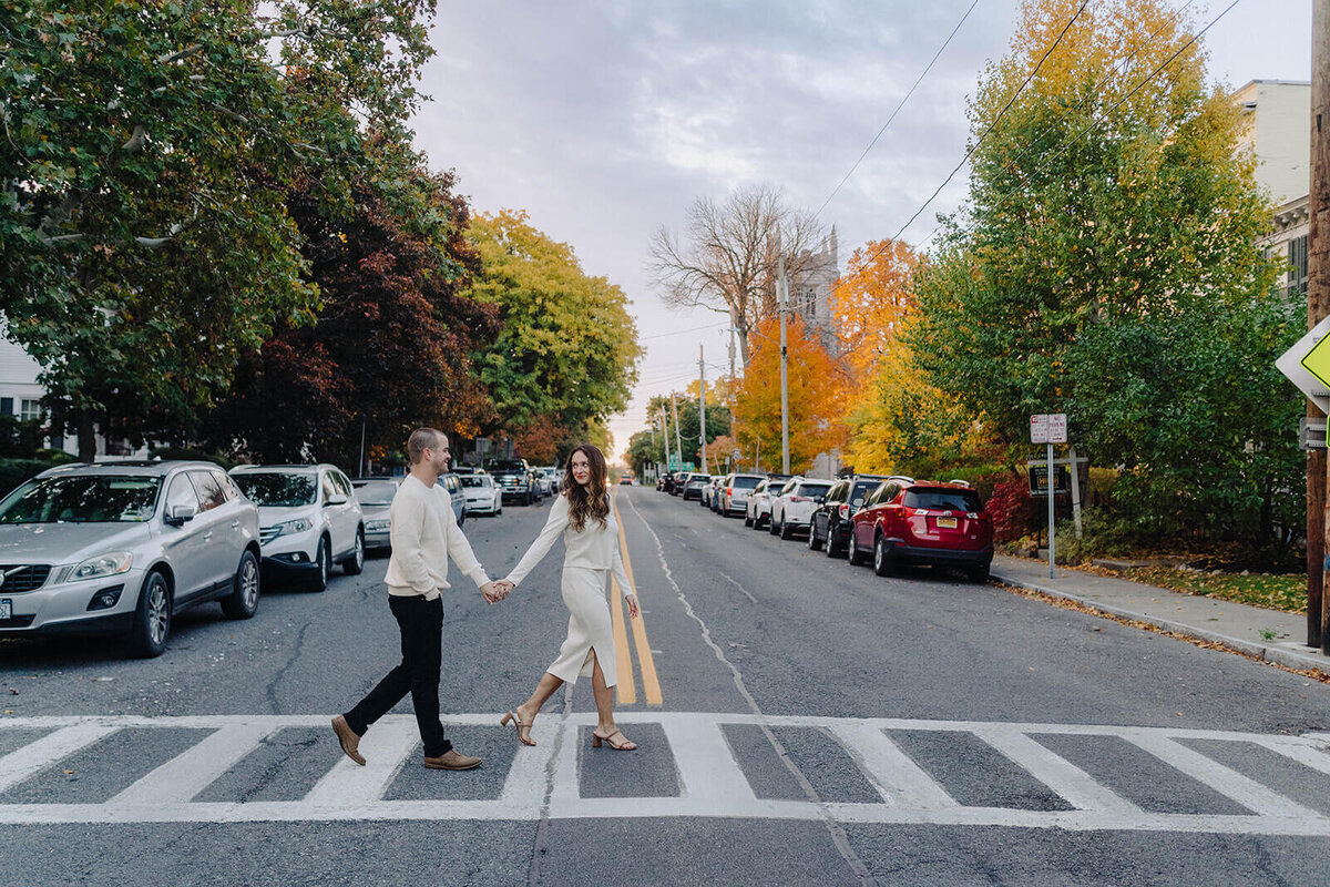 Couple walking across a road in Finger Lakes NY