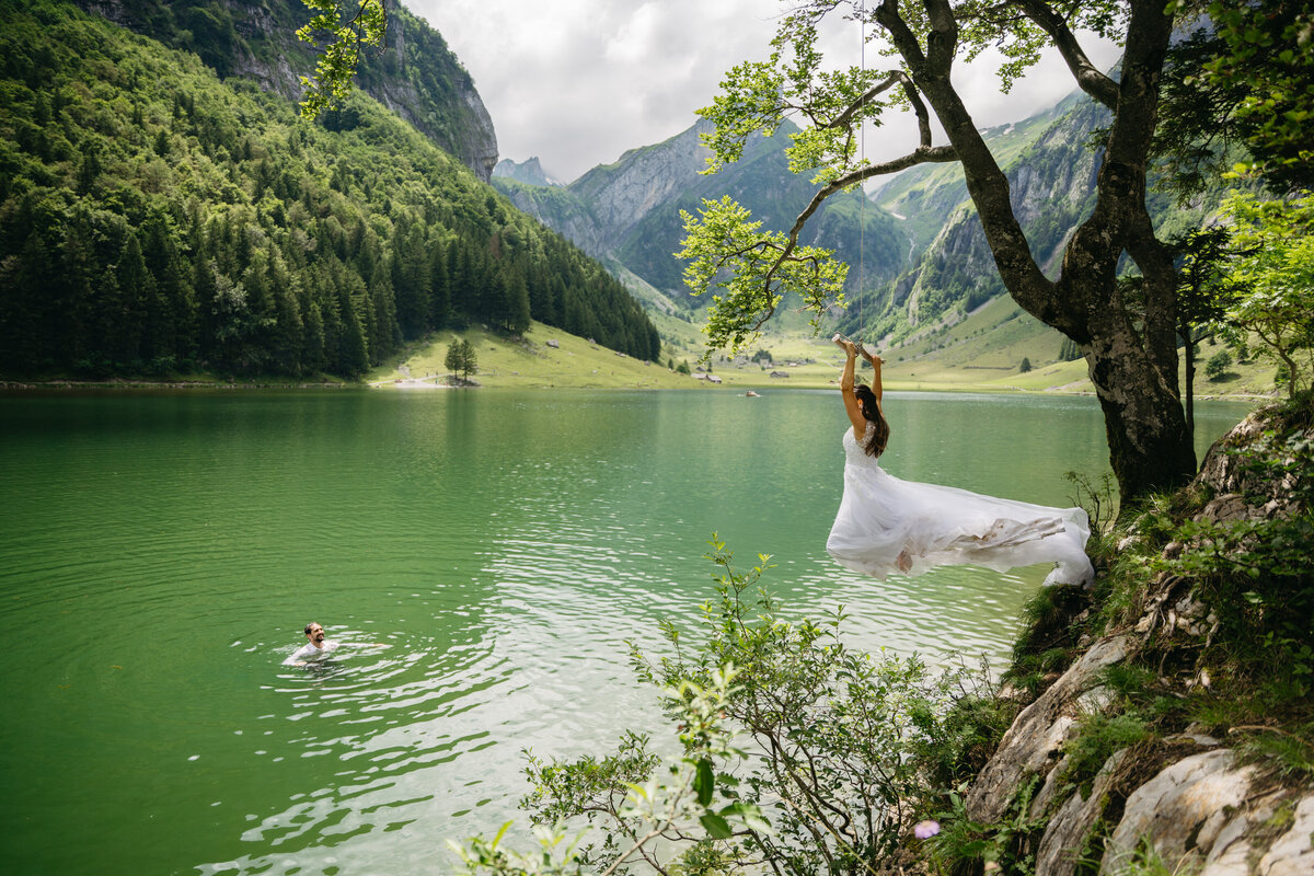 Bride using rope swing in Seealpsee