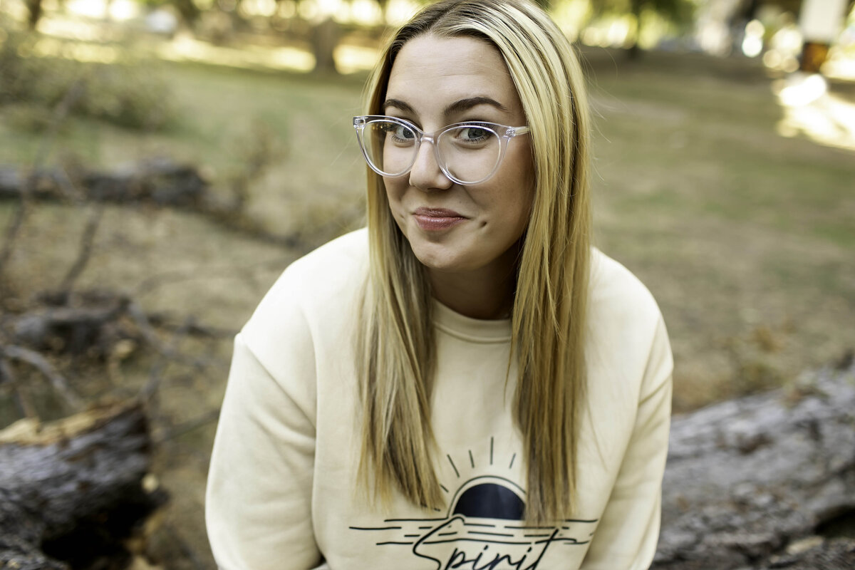 A high school senior smiles brightly, showcasing their excitement for what lies ahead