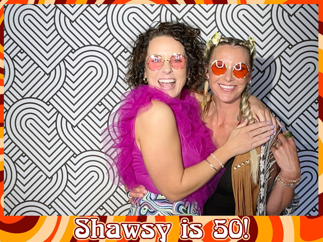70s themed guests pose in retro photo booth at 50th birthday party entertainment in christchurch