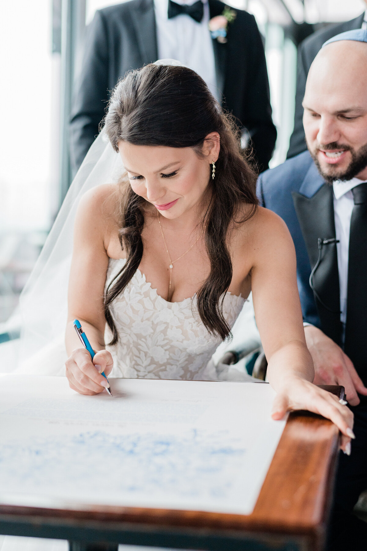 Bride signs legal documents at the wedding ceremony 