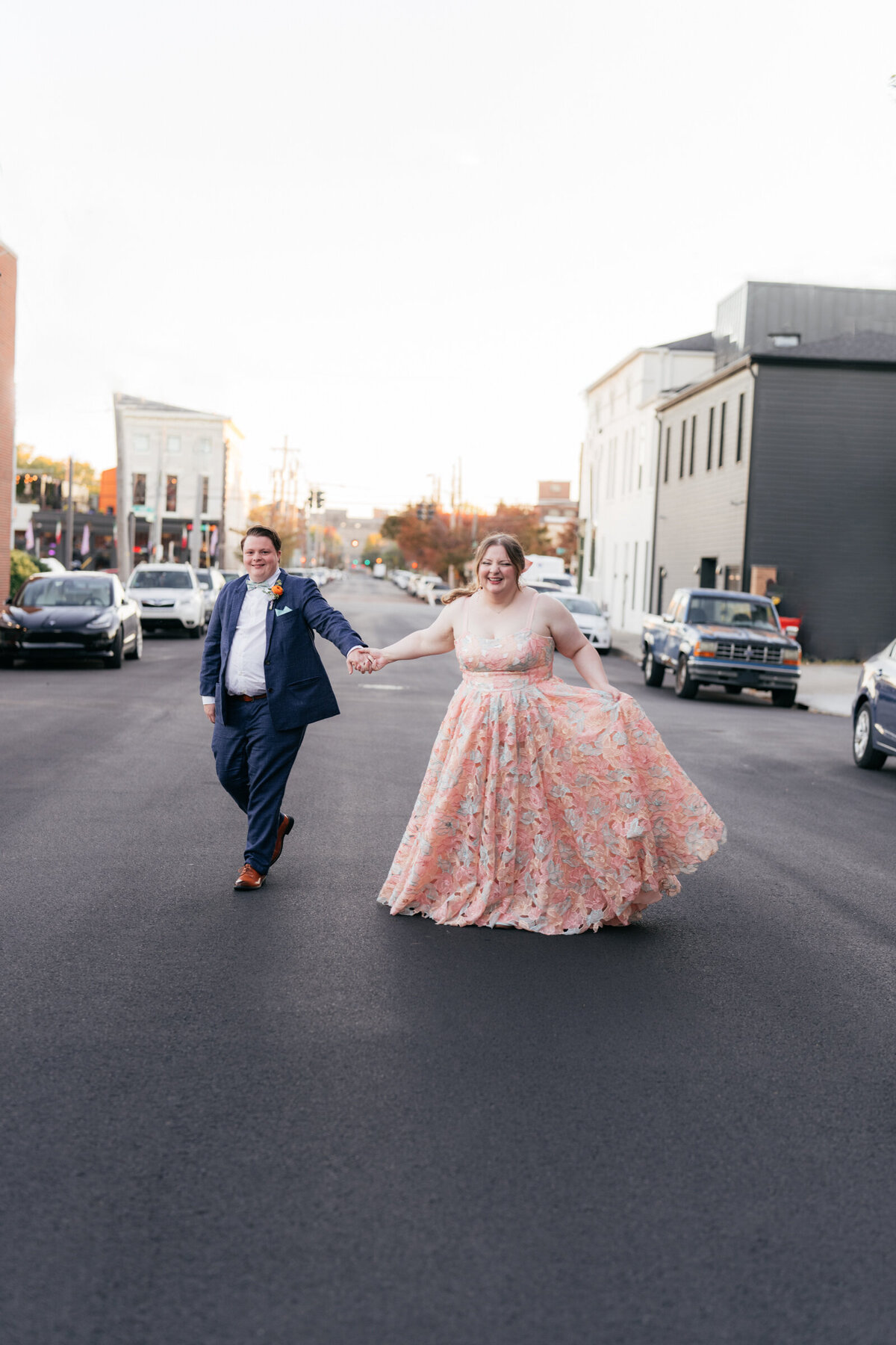 bride wearing colorful wedding dress walking with groom
