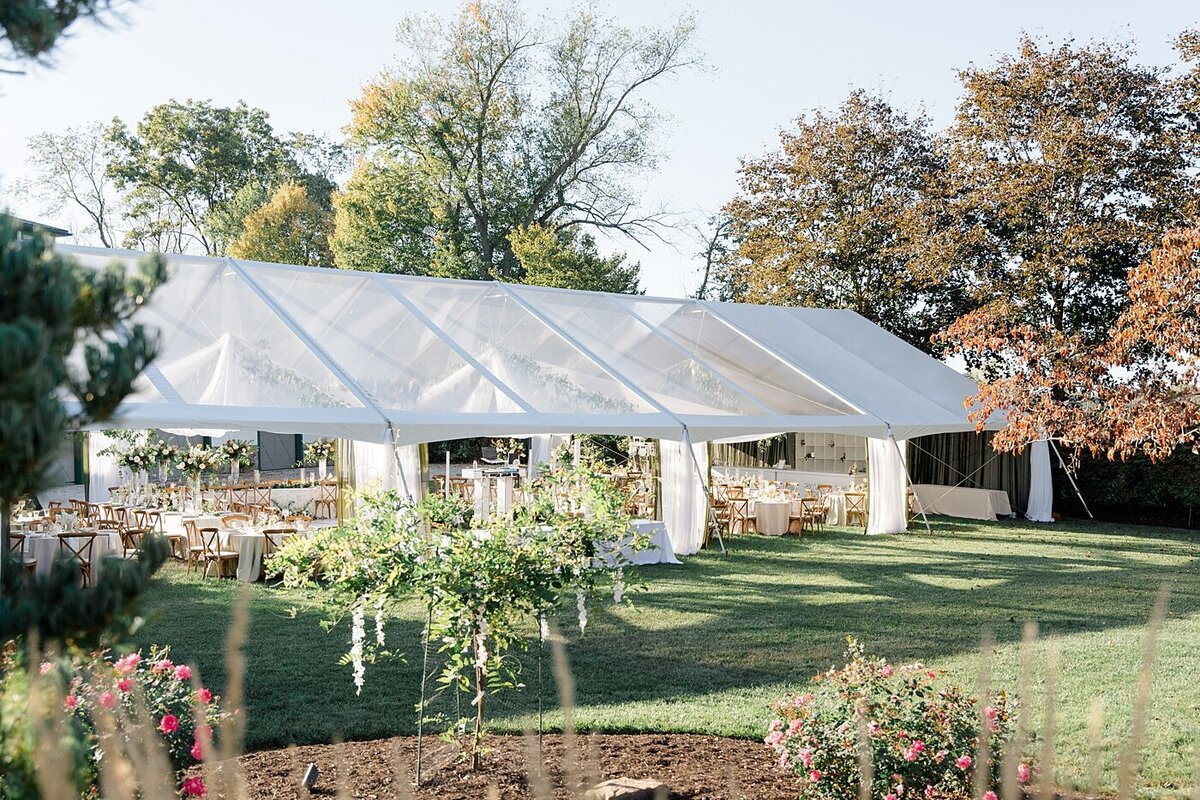backyard wedding with a large white tent set up for the wedding reception