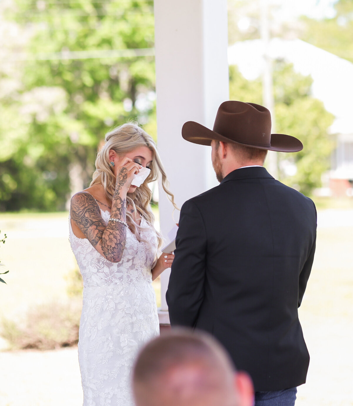 bride getting emotional during vows while wearing lace dress in Columbus Georgia by Columbus Georgia wedding photographer Amanda Richardson Photography