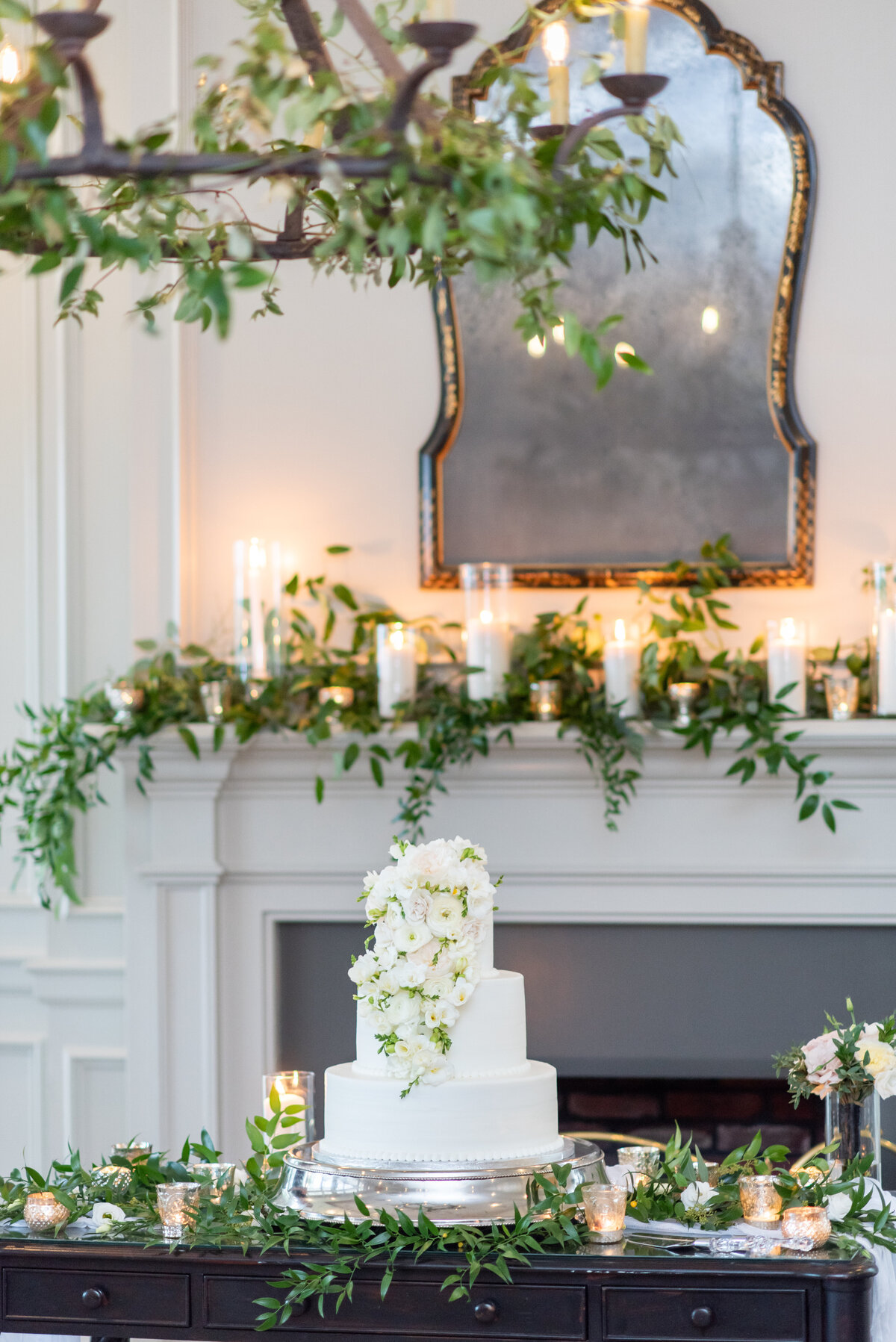 photo of white cake with greenery