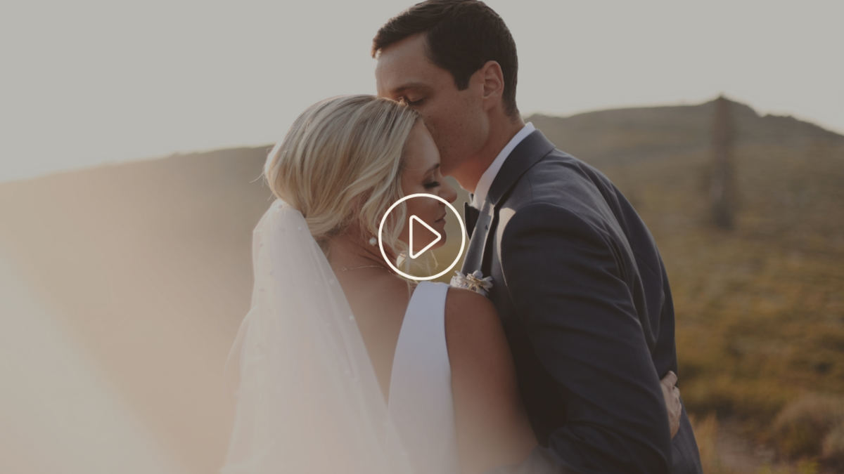 Groom Kissing Bride's Cheek At Elopement Outdoors