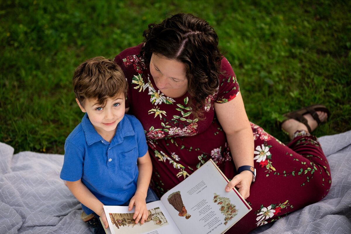 Mother and son read together on a blanket at Hayes Nature Preserve in  Alabama