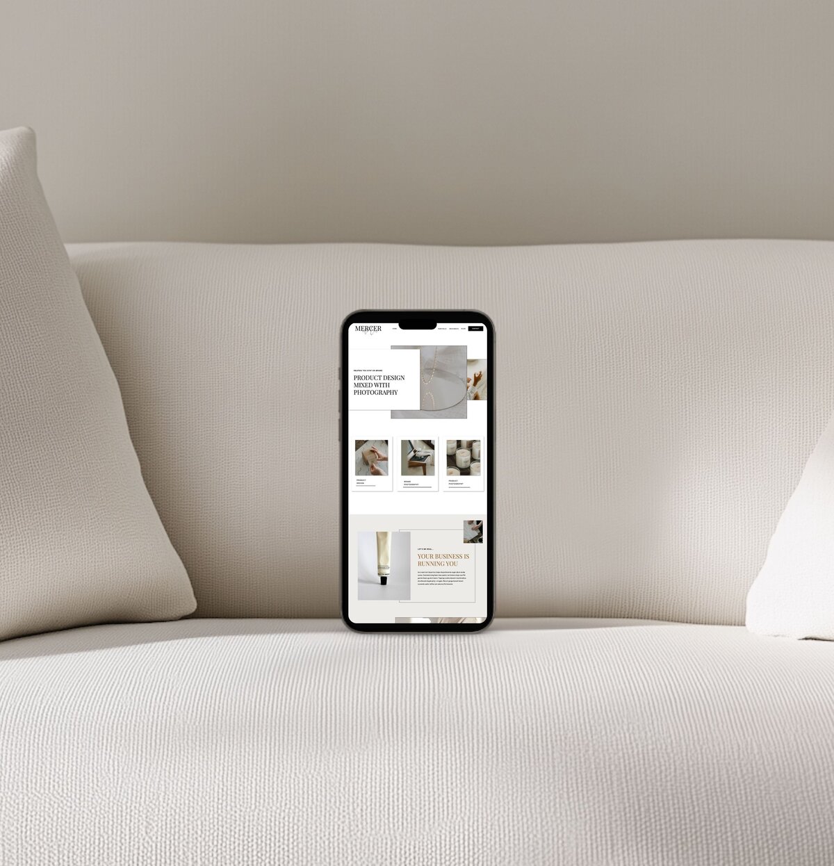 Mercer luxury mobile ShowIt template mockup on iPhone with warm neutral upholstery background — elegant website design for creatives.