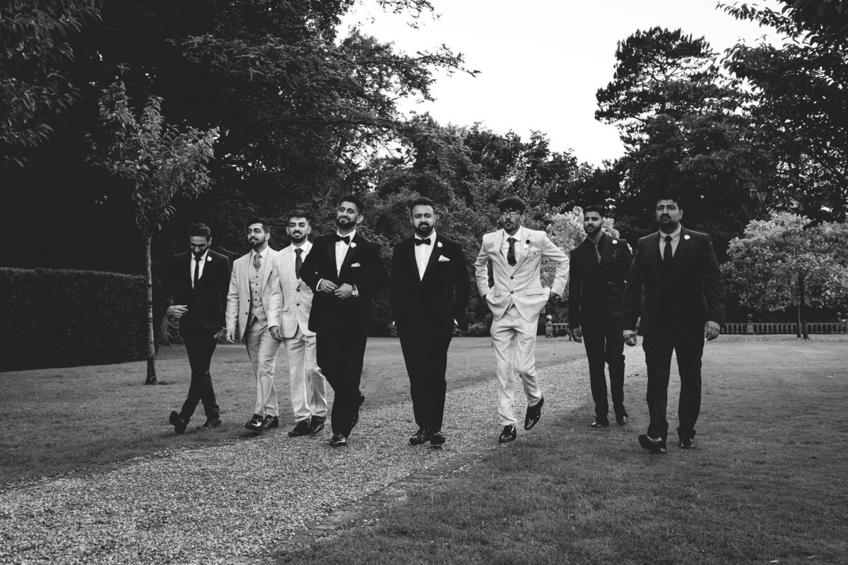 Eight Groomsmen walk side by side 2