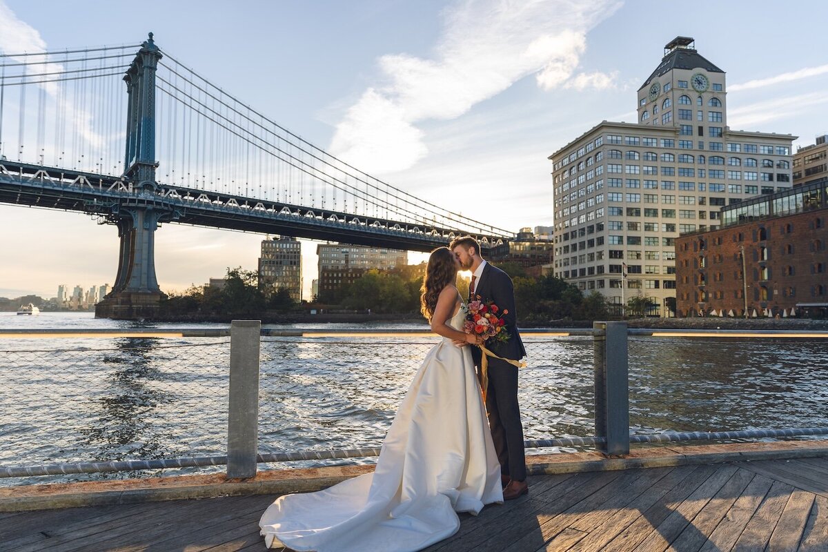 Bride and groom sharing sunset moment by Manhattan Bridge