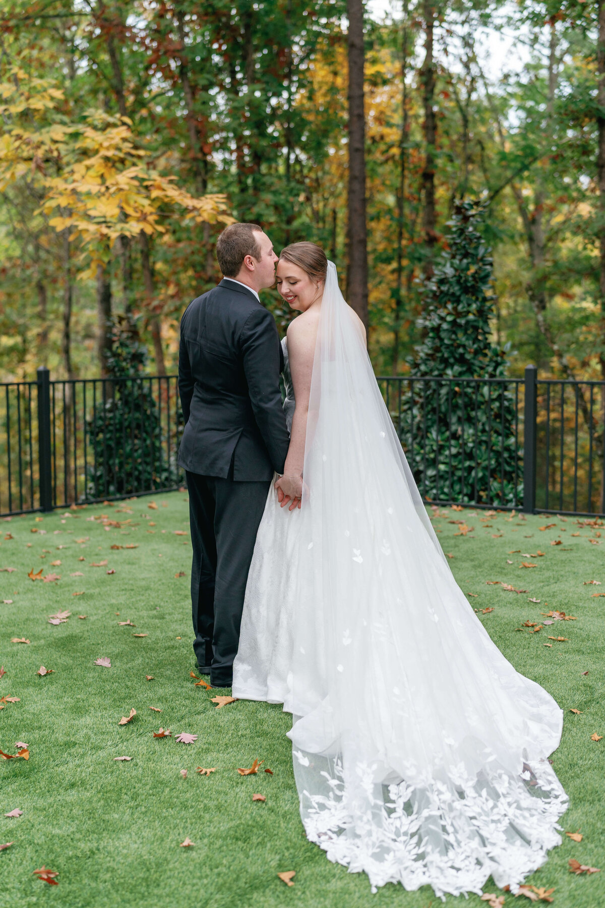 Groom kissing his bride for their pictures