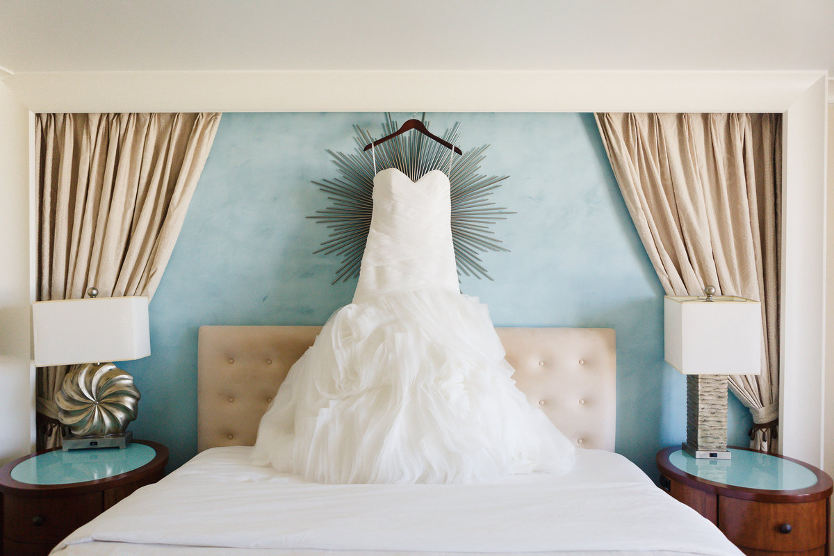 Wedding Dress Hanging Above Bed Prior to Traditional Jewish Wedding at One Ocean in Atlantic Beach Florida
