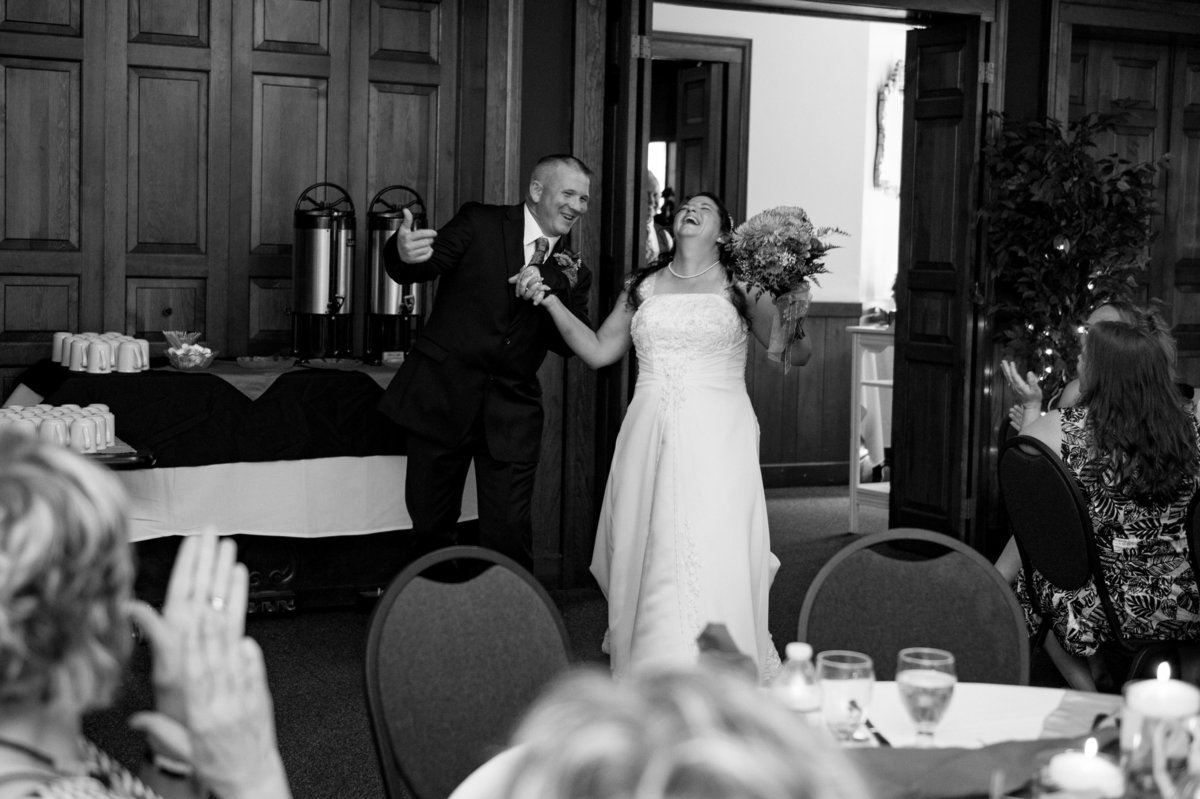 reception walk in bride laughs tosses head back