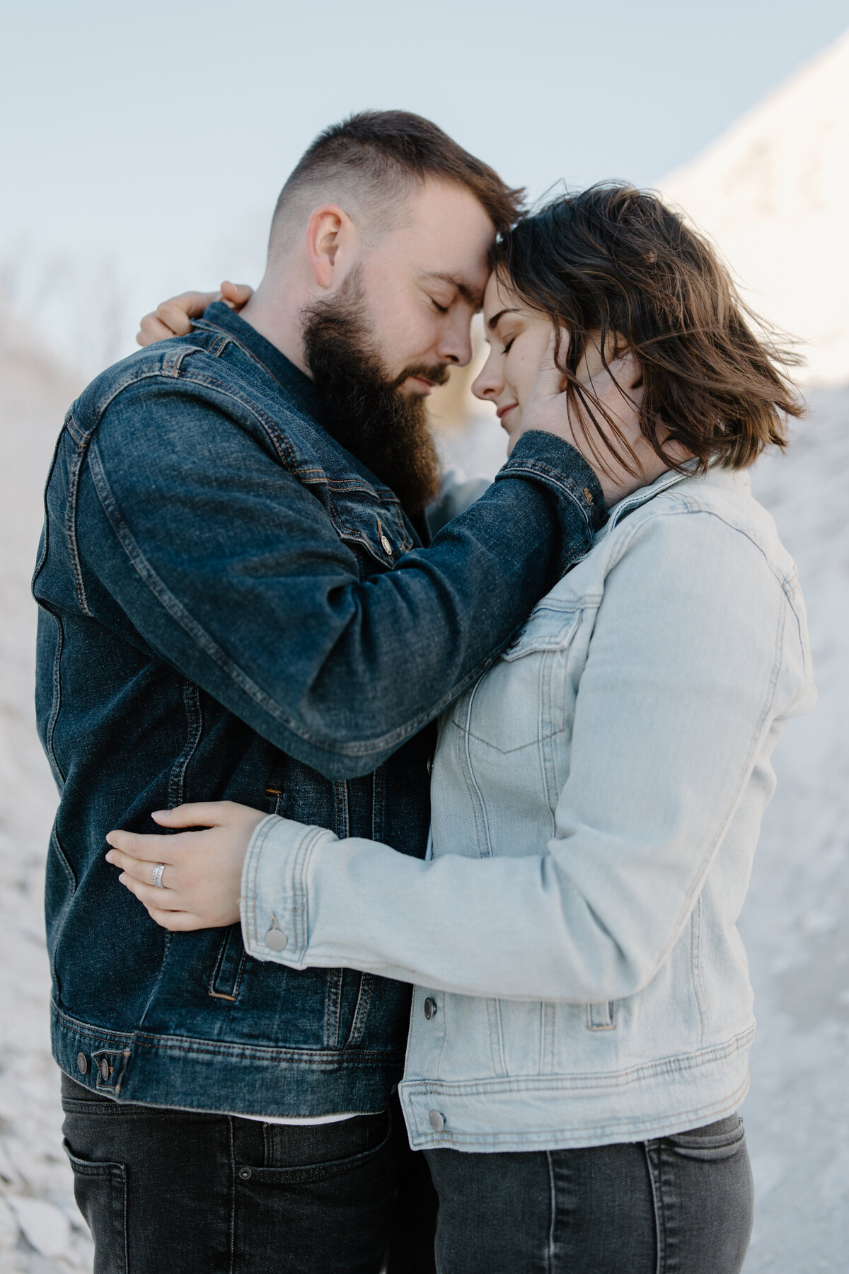 couple embracing at white cliffs of conoy wearing casual jean jackets