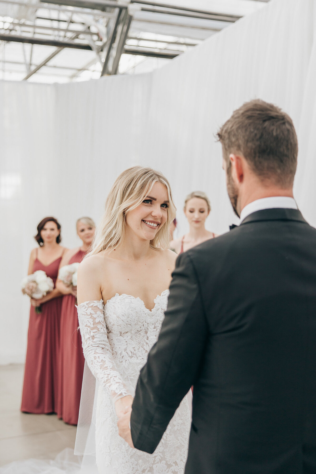 Candid photo of bride smiling at groom during luxurious wedding ceremony