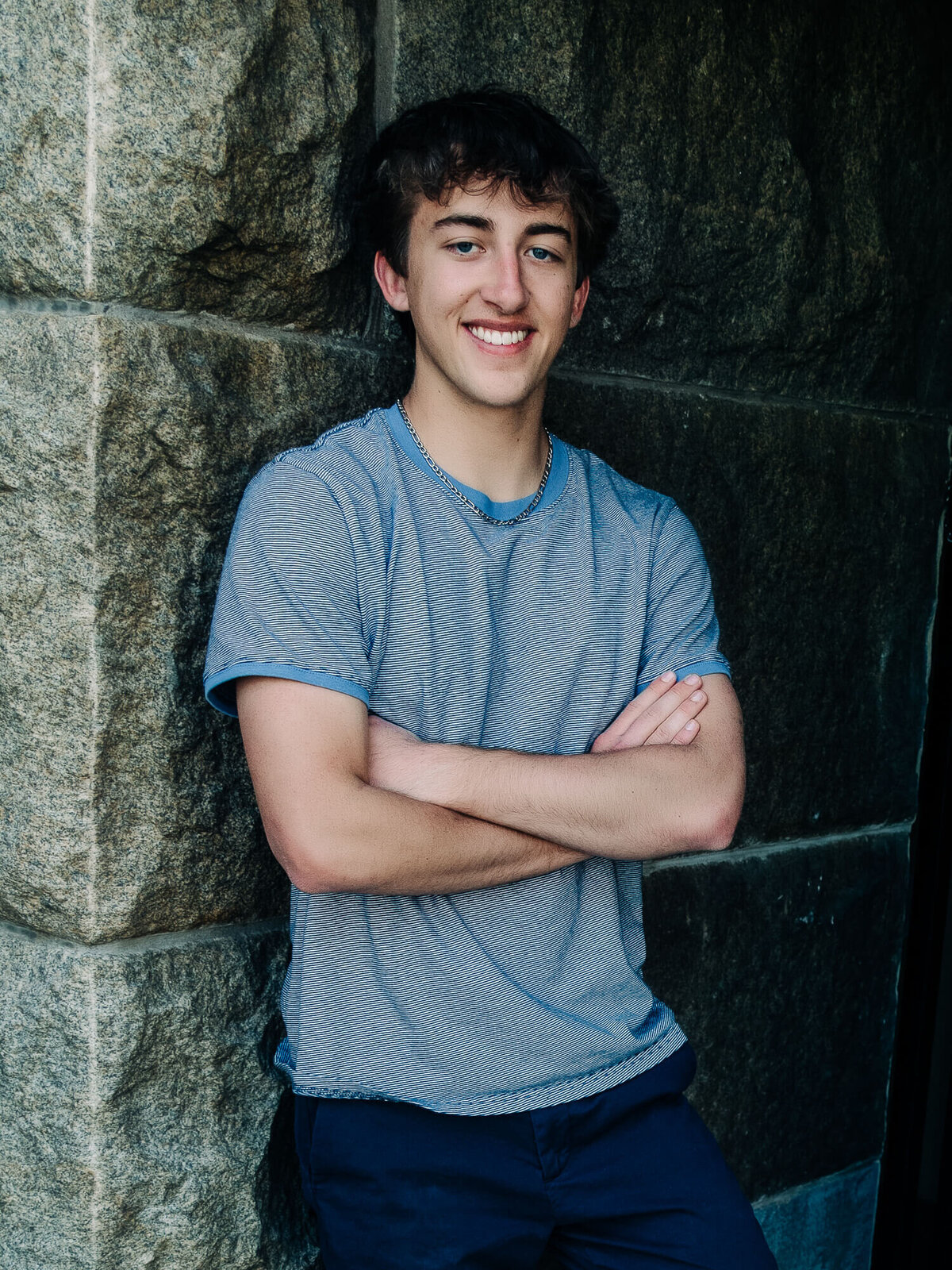 Boy poses against a wall in Prescott senior photography session