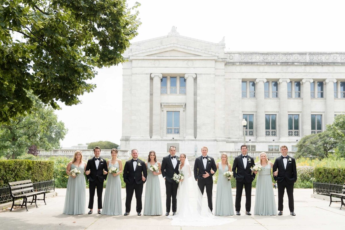 Full wedding party photo outside the Field Museum before their Luxury Chicago Outdoor Historic Wedding Venue.